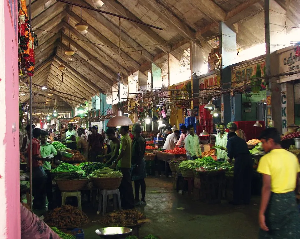 Fresh produce and traders in the busy wholesale vegetable halls of Koyambedu market