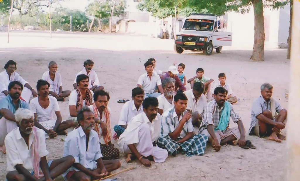 Village farmers seated on the ground during an information session near Kurnool